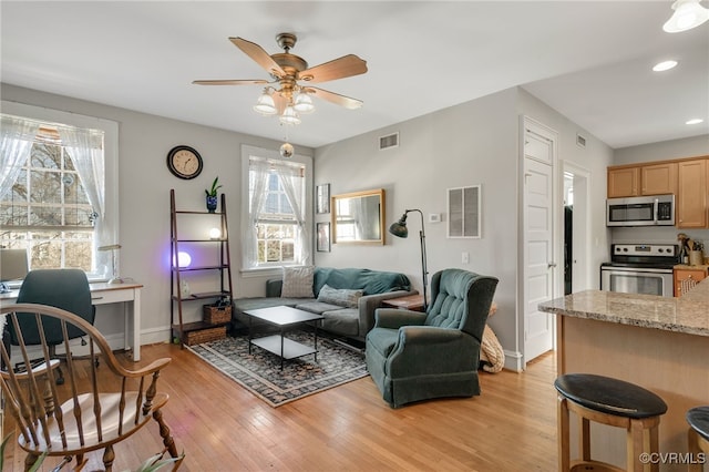 living room with visible vents, plenty of natural light, and light wood finished floors