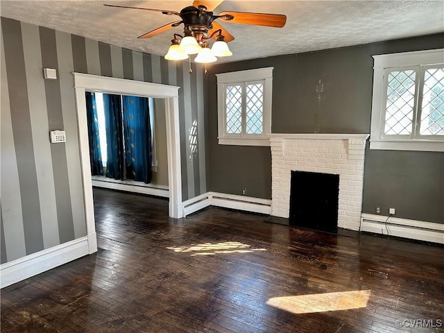 unfurnished living room with wood-type flooring, a baseboard heating unit, and a textured ceiling