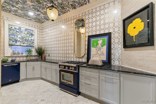 kitchen featuring dishwasher, dark stone countertops, a sink, and gas range