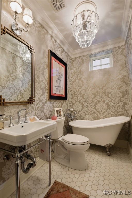 full bath featuring visible vents, toilet, tile patterned flooring, a freestanding bath, and crown molding