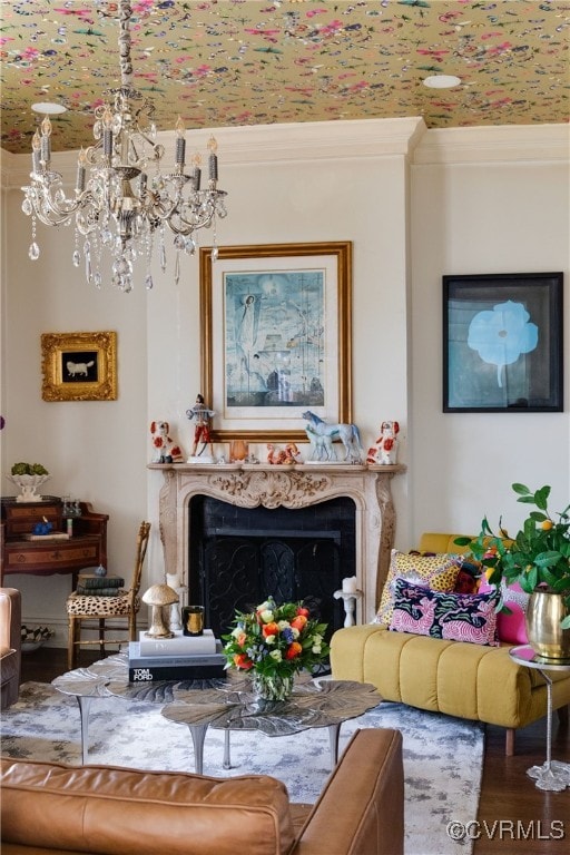 living room featuring a fireplace, crown molding, and wood finished floors