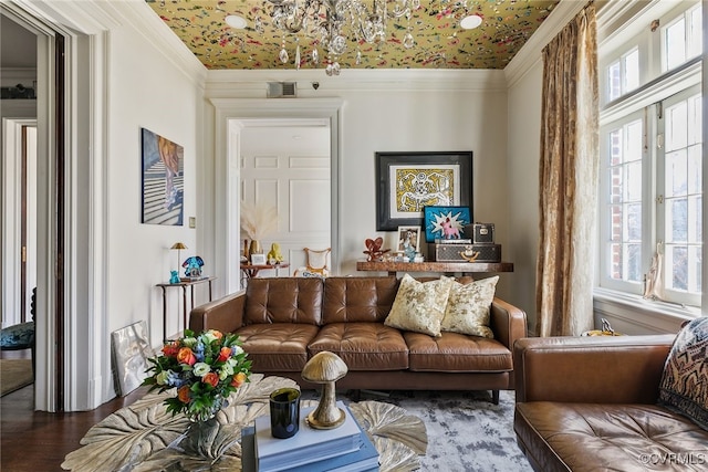 living area featuring visible vents, crown molding, and wood finished floors