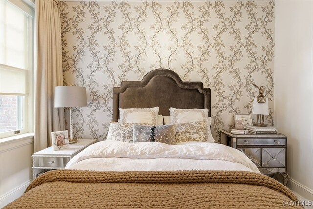 bedroom featuring baseboards and wallpapered walls