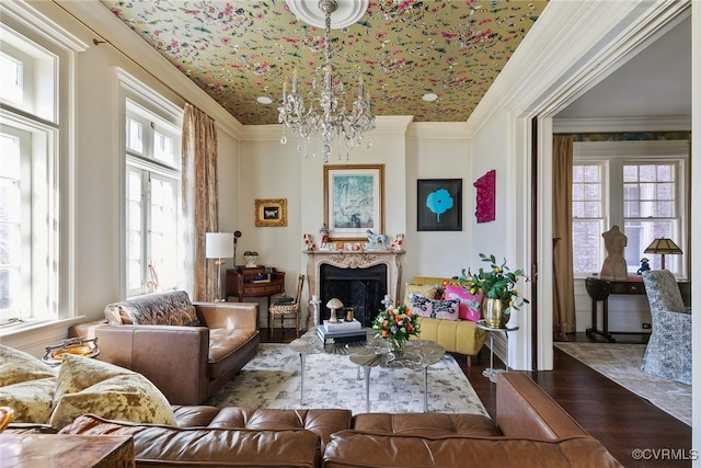 sitting room featuring a notable chandelier, a fireplace, crown molding, and wood finished floors