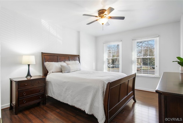 bedroom with dark wood-style flooring, ceiling fan, and baseboards