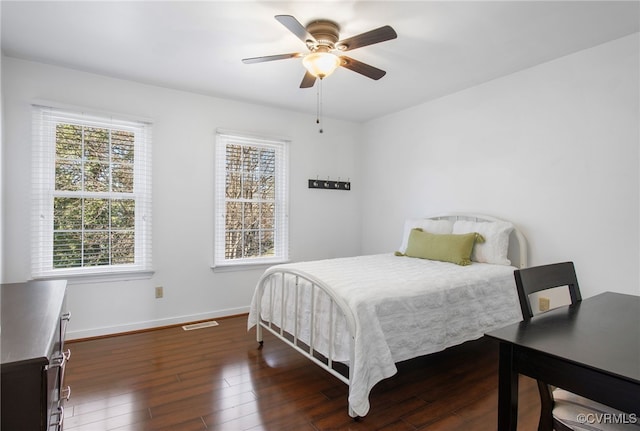 bedroom featuring baseboards, multiple windows, visible vents, and dark wood-style flooring