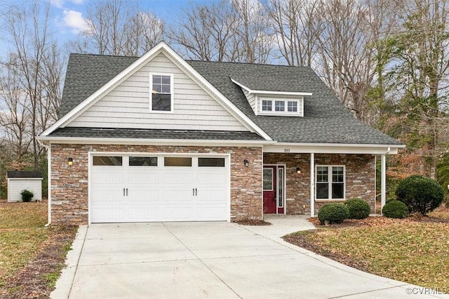 view of front of home featuring a shingled roof, driveway, and an attached garage