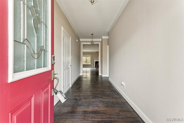 corridor with dark wood-style floors, baseboards, and ornamental molding