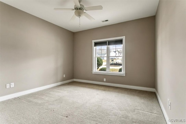 spare room featuring a ceiling fan, carpet, visible vents, and baseboards