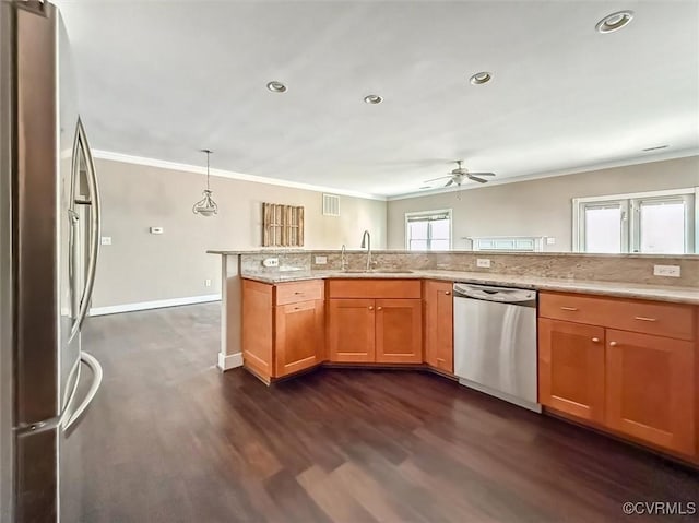 kitchen featuring stainless steel appliances, ornamental molding, a sink, and dark wood finished floors