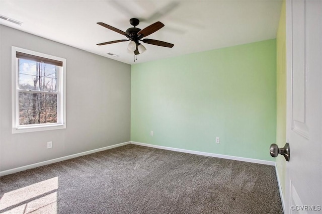 empty room featuring carpet floors, baseboards, visible vents, and ceiling fan