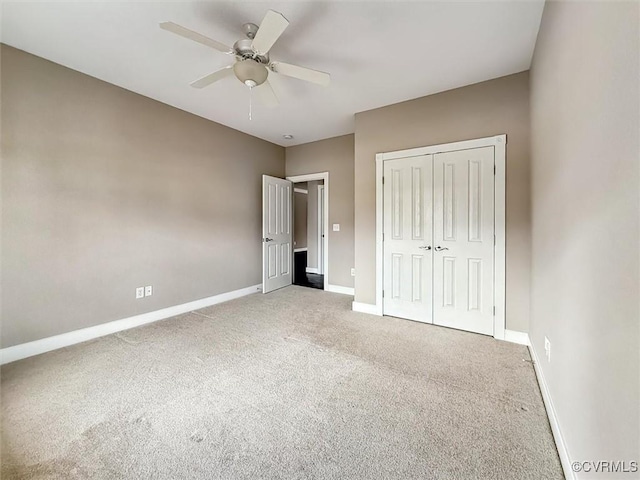 unfurnished bedroom with a closet, carpet flooring, ceiling fan, and baseboards