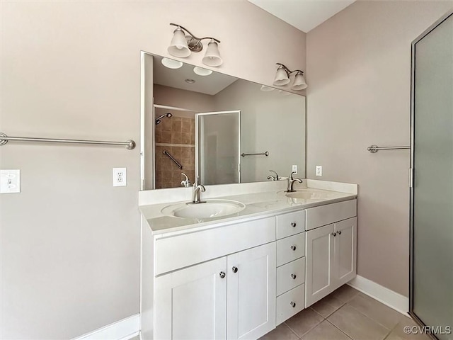 full bath featuring double vanity, tile patterned flooring, an enclosed shower, and a sink