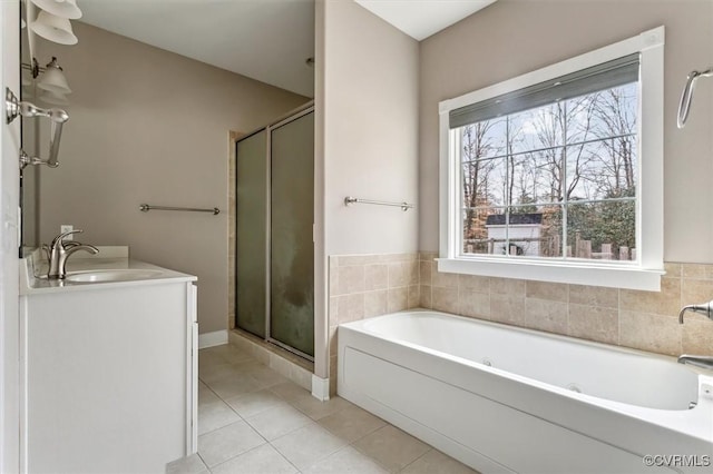 bathroom with a shower stall, a sink, a bath, and tile patterned floors