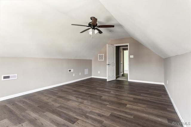 bonus room with visible vents, baseboards, a ceiling fan, dark wood-style floors, and vaulted ceiling