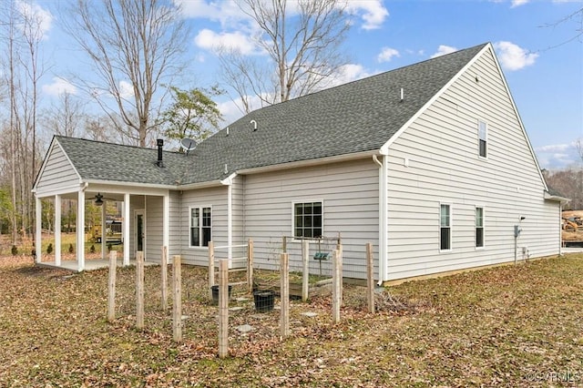 back of property featuring ceiling fan, roof with shingles, and a patio area