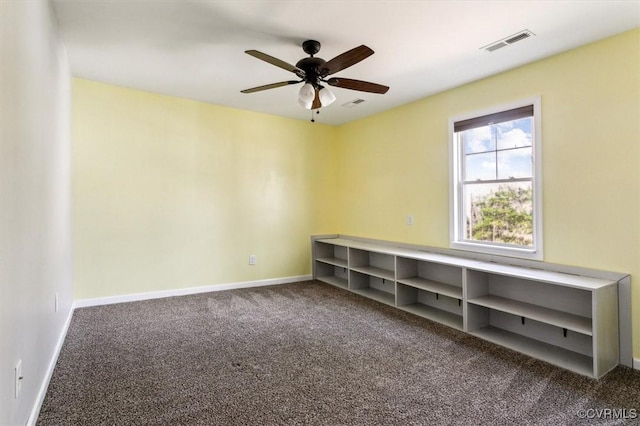 unfurnished room featuring a ceiling fan, carpet, visible vents, and baseboards