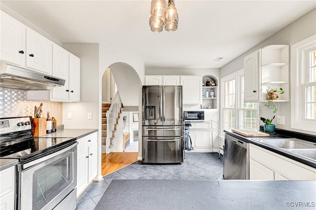 kitchen featuring open shelves, appliances with stainless steel finishes, white cabinetry, and under cabinet range hood