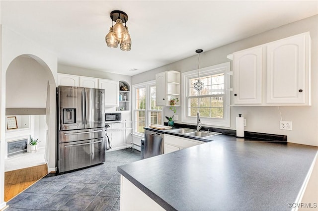 kitchen featuring a sink, white cabinetry, appliances with stainless steel finishes, open shelves, and dark countertops