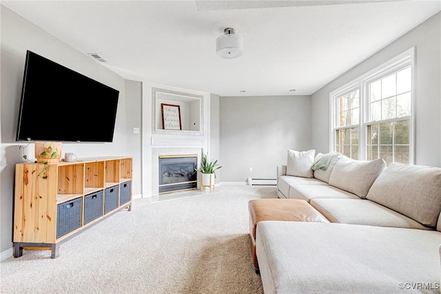 living room with a fireplace, light colored carpet, visible vents, a baseboard heating unit, and baseboards