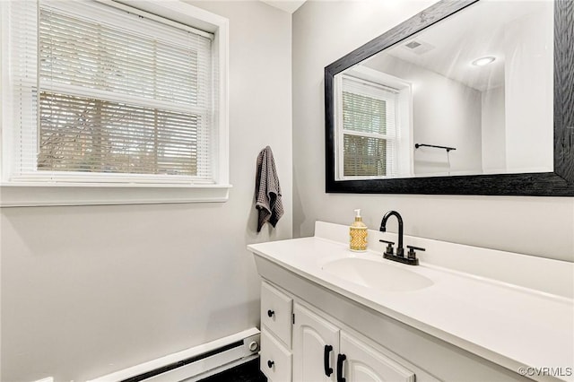 bathroom featuring visible vents, a baseboard radiator, and vanity