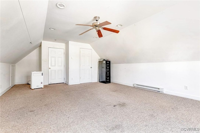 bonus room featuring light carpet, baseboards, ceiling fan, vaulted ceiling, and a baseboard heating unit