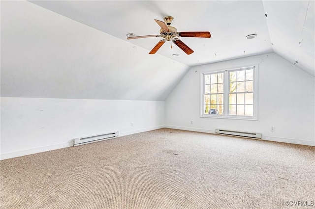 additional living space featuring lofted ceiling, baseboard heating, and carpet