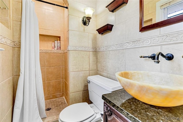 full bath featuring toilet, a stall shower, tile walls, and vanity