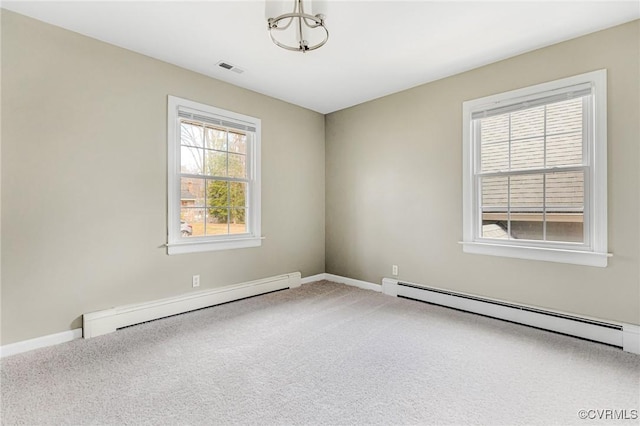 carpeted empty room featuring a baseboard radiator, visible vents, and baseboards