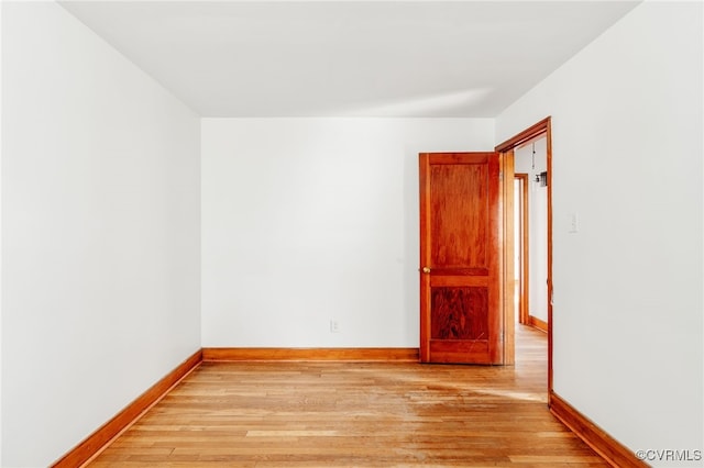 empty room featuring light wood-style flooring and baseboards