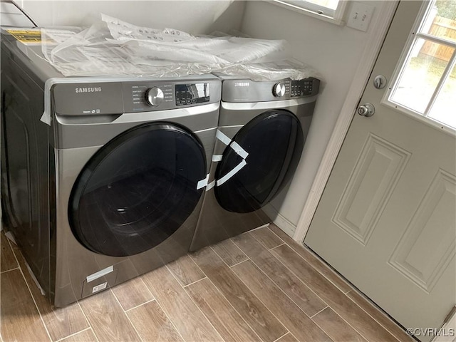 washroom featuring laundry area, wood finish floors, and independent washer and dryer