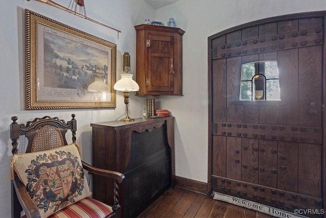 entryway with baseboards and dark wood-style flooring