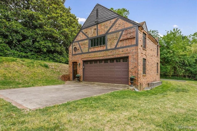 tudor house featuring a garage, concrete driveway, brick siding, and a front lawn