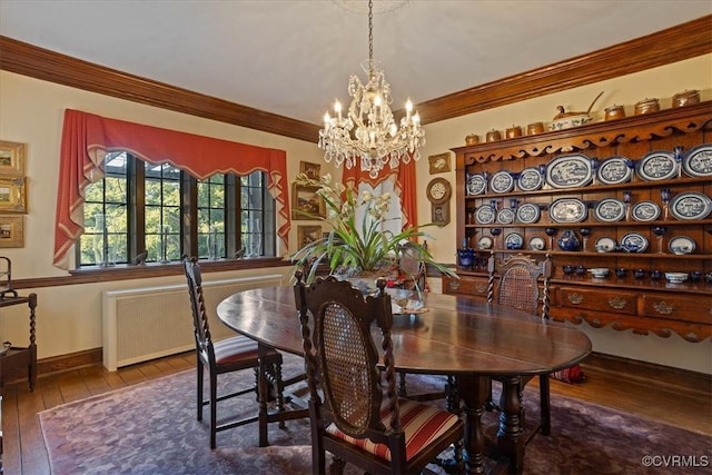 dining room featuring a chandelier, baseboards, radiator, wood-type flooring, and crown molding