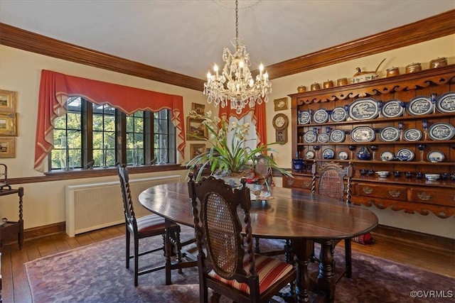 dining space with radiator, an inviting chandelier, ornamental molding, and hardwood / wood-style floors