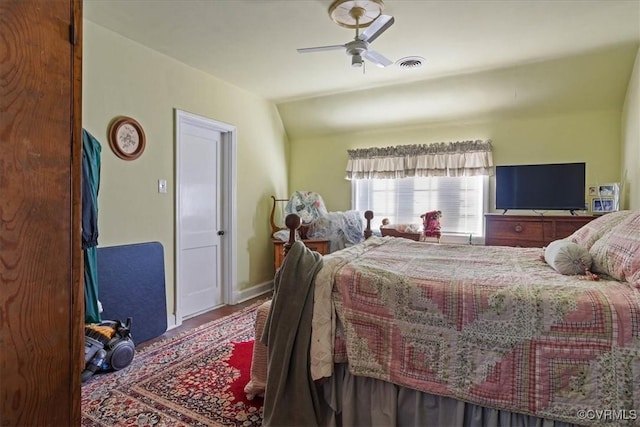 bedroom with vaulted ceiling, visible vents, and ceiling fan