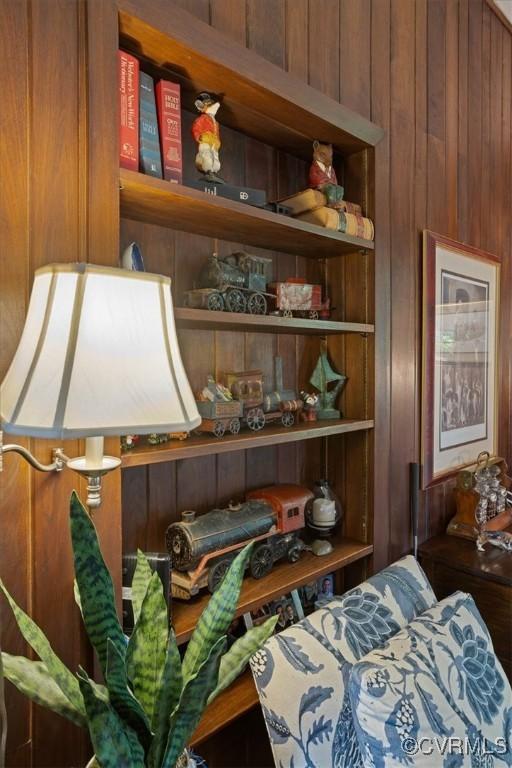 bedroom featuring wooden walls