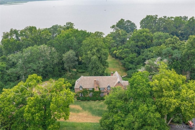 birds eye view of property featuring a wooded view and a water view
