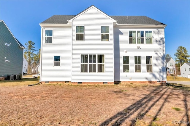 back of property featuring crawl space, a lawn, cooling unit, and roof with shingles