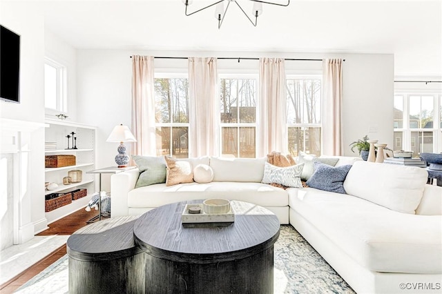 living room featuring an inviting chandelier and wood finished floors