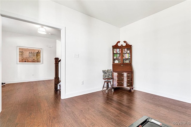 empty room featuring baseboards and wood finished floors