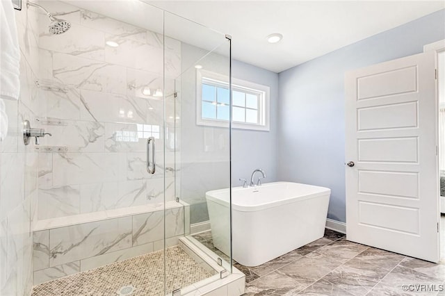 full bath with marble finish floor, a stall shower, and a soaking tub