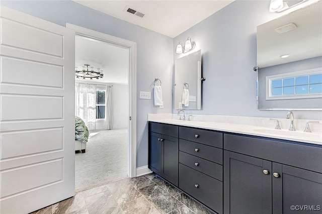 full bath with double vanity, ensuite bath, a sink, and visible vents