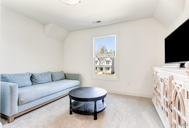 living area with baseboards, visible vents, vaulted ceiling, and carpet flooring