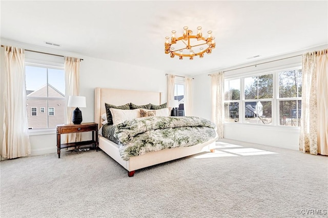 carpeted bedroom with multiple windows and visible vents