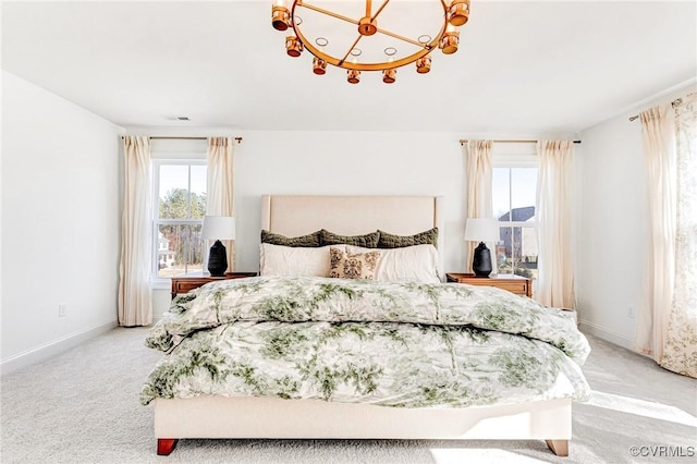 bedroom with an inviting chandelier, baseboards, and light colored carpet