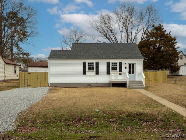 view of front of property with a deck, a shingled roof, fence, crawl space, and gravel driveway