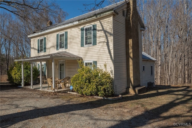 1566 Ballsville Rd, Powhatan, VA 23139 - view of front facade with covered porch, a chimney, and a metal roof