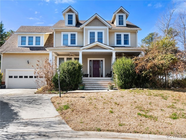 view of front of home featuring a garage, concrete driveway, a porch, and roof with shingles