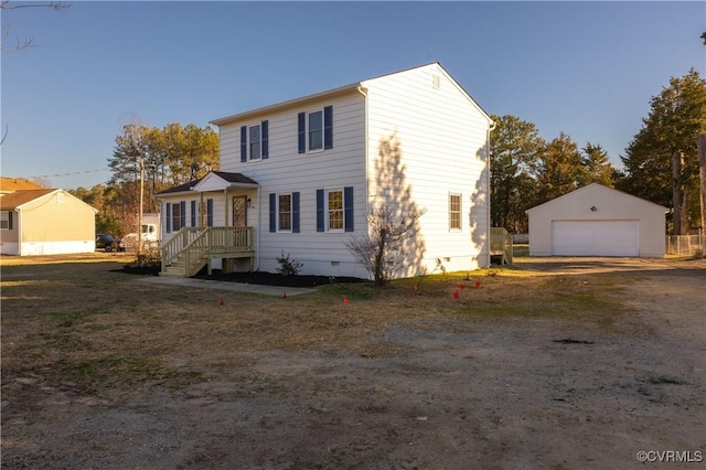 view of front of house featuring a garage, crawl space, and an outdoor structure